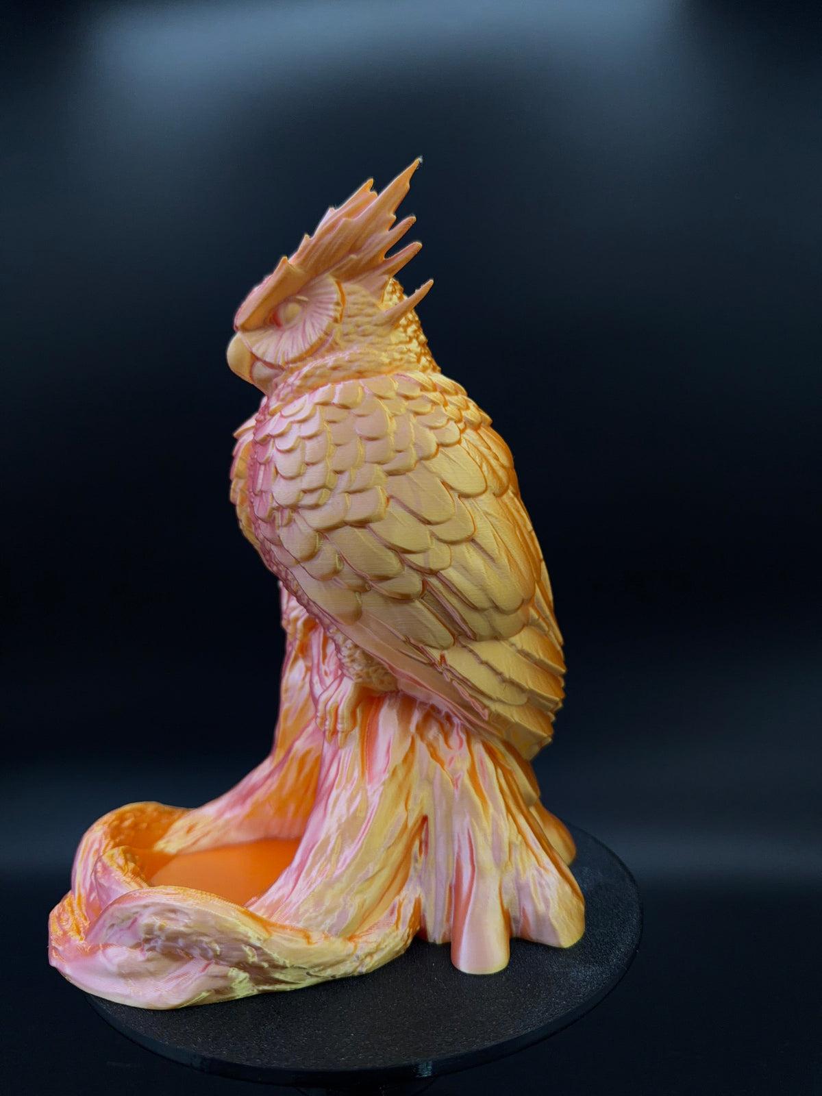 The Omen Owl dice tower in a pink and gold silk finish with its catch tray at the base