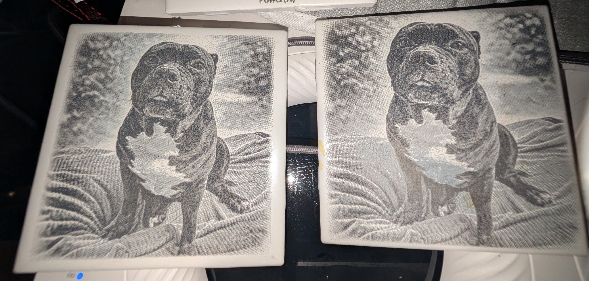 Custom pet MemoryTile process example showing engraved dog photo tiles during testing