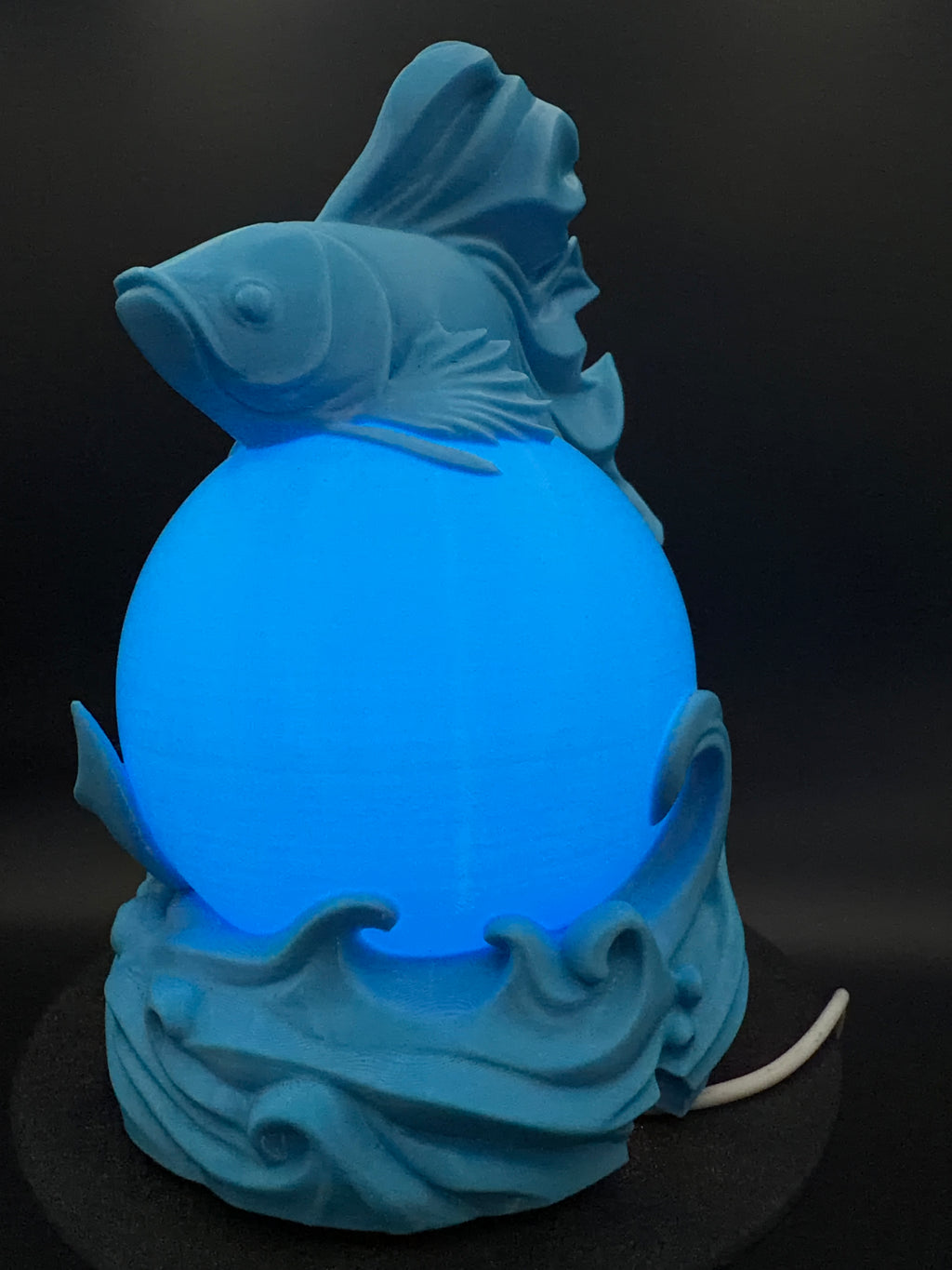 Blue Betta lamp illuminated, side view