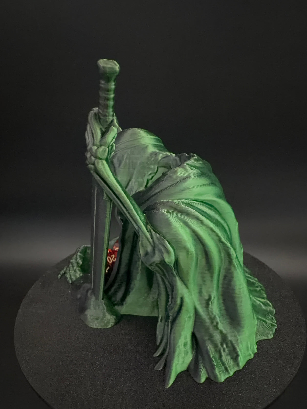 Side view of hooded skeletal figure with sword