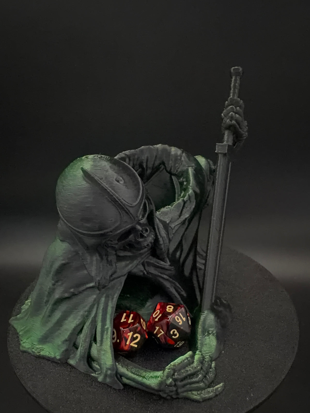Front view of hooded skeletal dice tower with dice