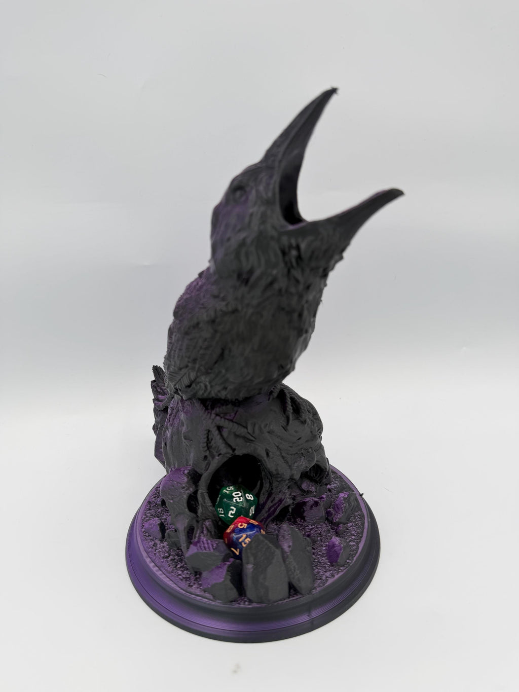 Hollow Crow dice tower – Black Purple – front view with open beak and dice in the catch tray