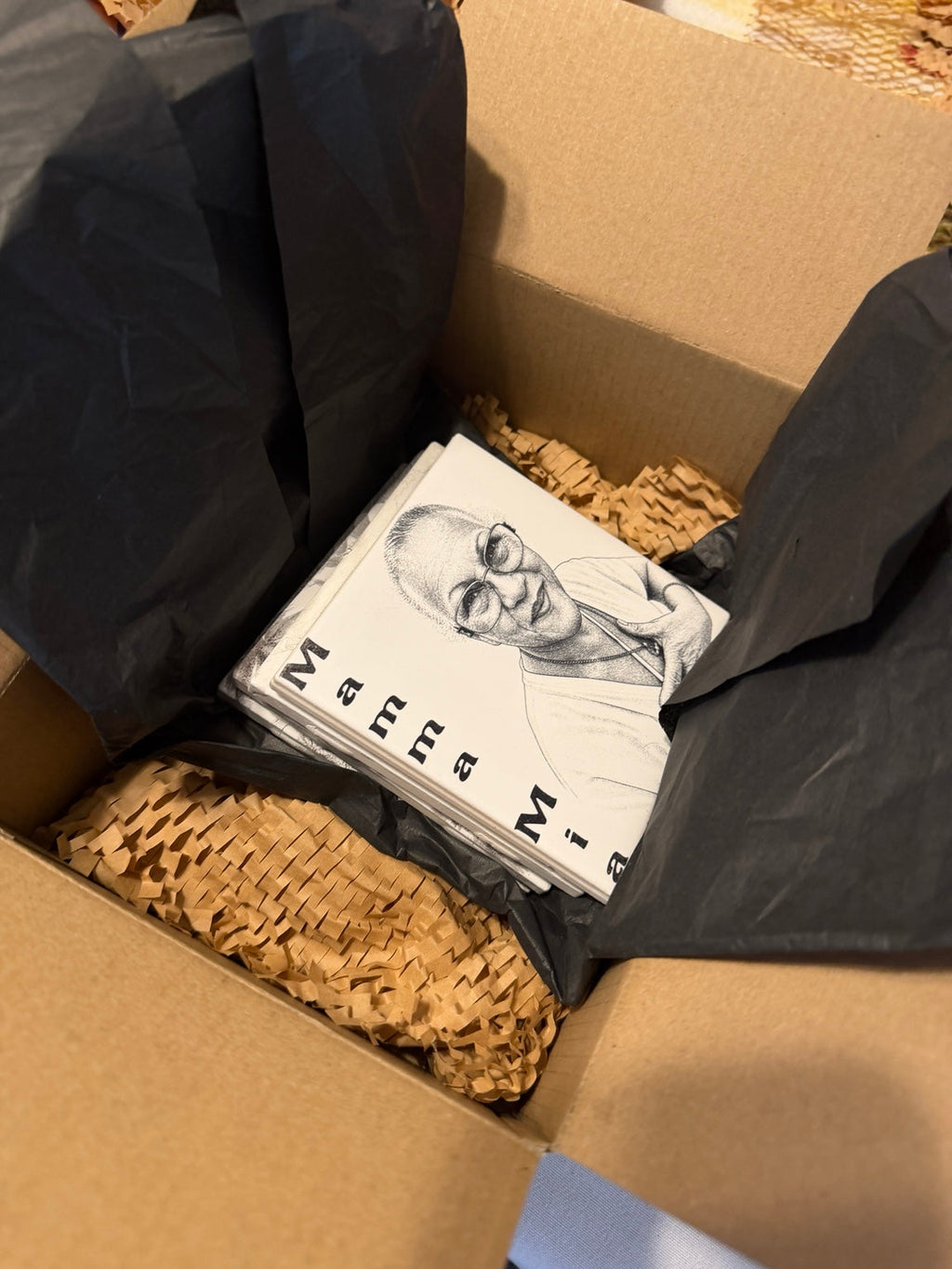 Custom photo keepsake tiles packed in kraft crinkle paper with black tissue