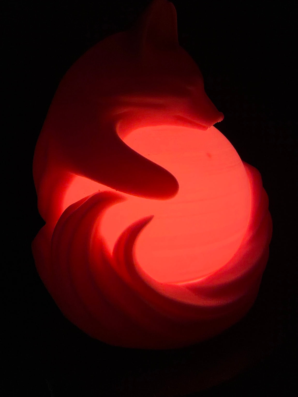 Pink fox lamp glowing from the side