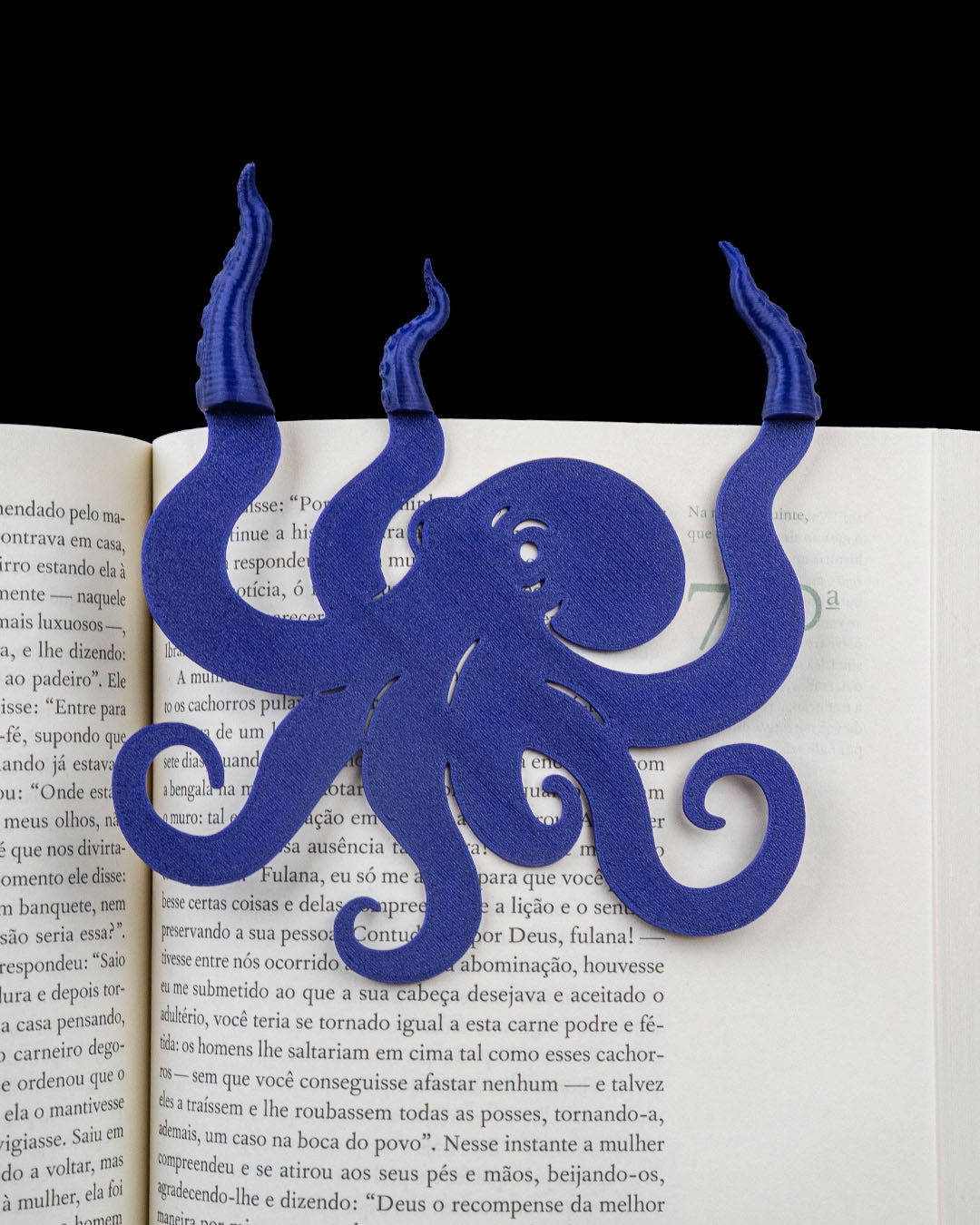Blue collectible bookmark shown on an open book
