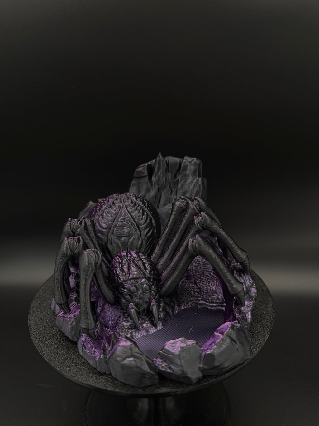 Front view of black and purple spider dice tower