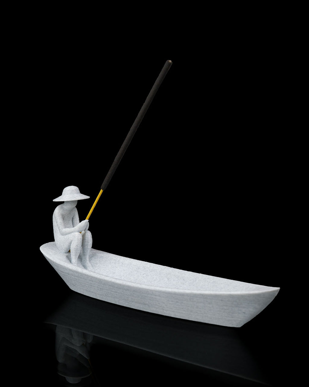 Still Waters incense holder angled hero view with boat-shaped tray seated figure and incense stick on black background