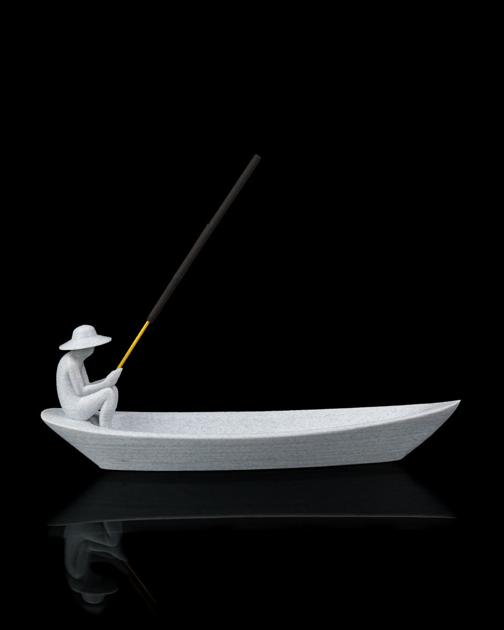 Still Waters incense holder side profile showing boat-shaped holder with seated figure and incense stick