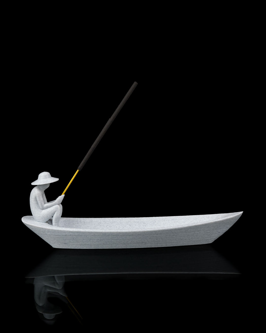 Still Waters incense holder side profile showing boat-shaped holder with seated figure and incense stick