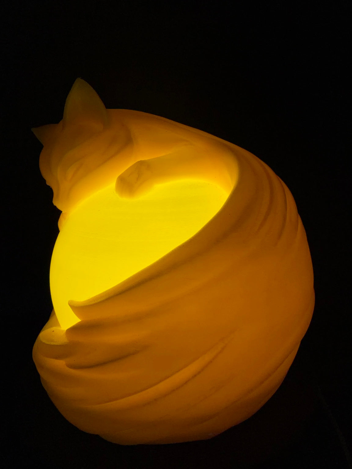 Yellow Cat lamp lit from an angled view