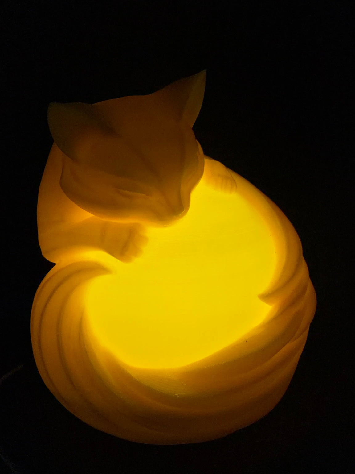 Yellow Cat LED lamp illuminated, front view